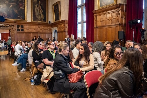 Conference attendees talking inside Oxford Town Hall